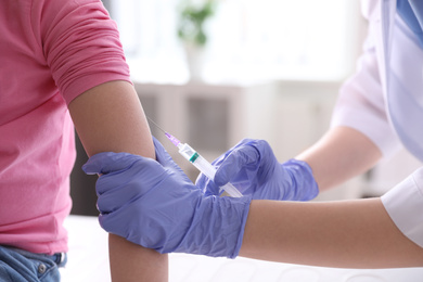 Little girl receiving chickenpox vaccination in clinic, closeup. Varicella virus prevention