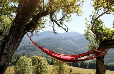 Empty comfortable hammock in mountains on sunny day
