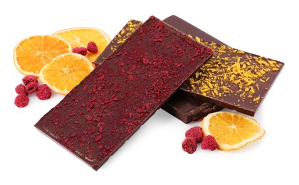 Chocolate bars with freeze dried fruits, raspberries and orange slices on white background