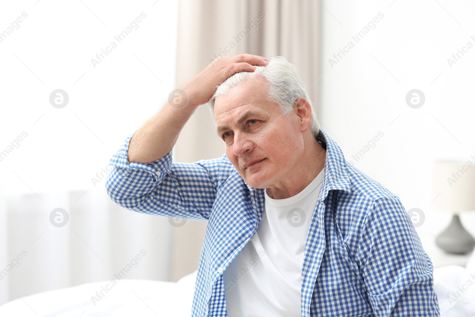 Photo of Senior man with hair loss problem indoors