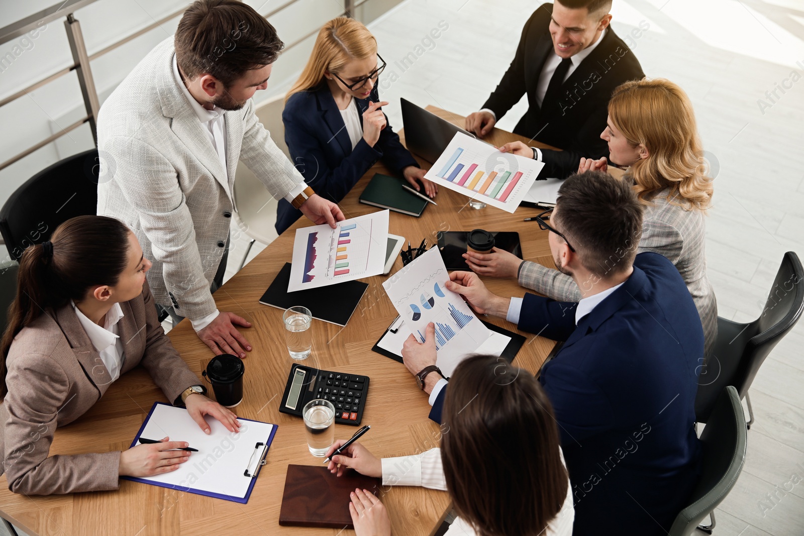 Photo of Businesspeople having meeting in office. Management consulting