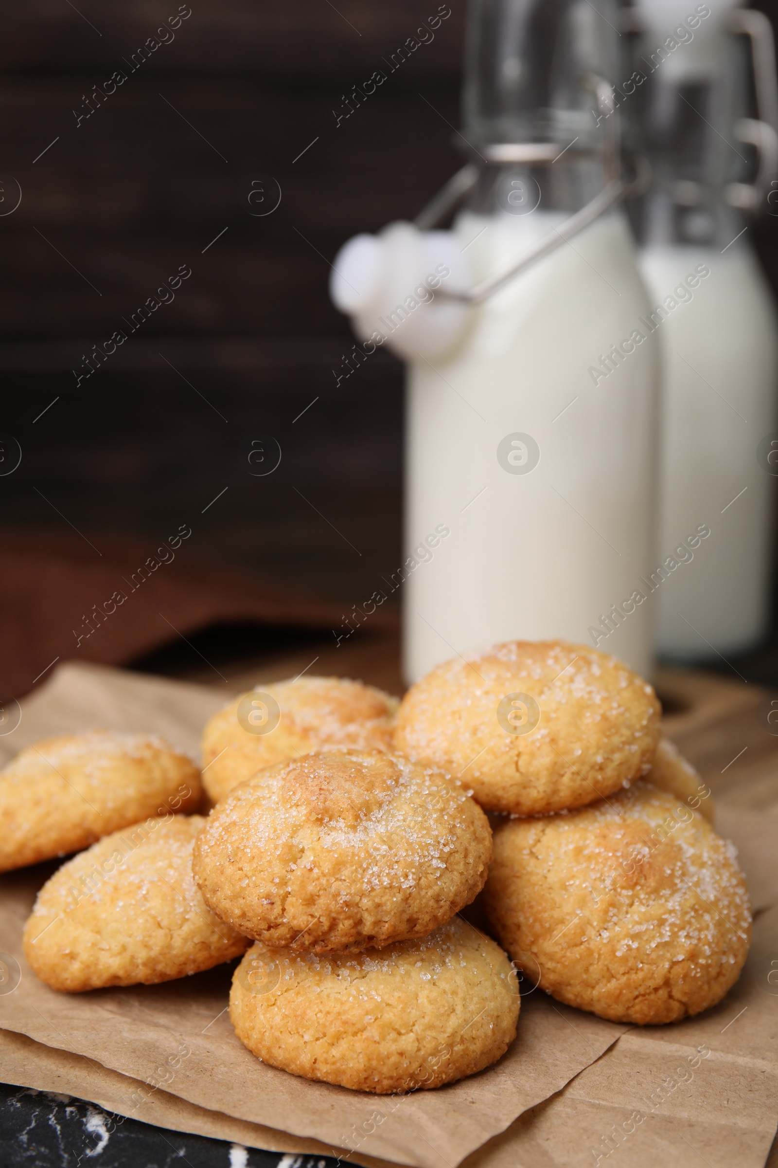 Photo of Tasty sweet sugar cookies and milk on table, closeup