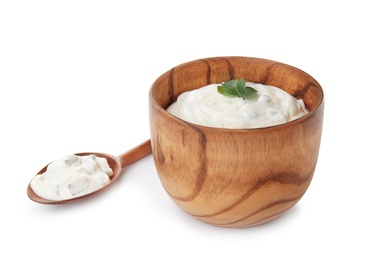 Bowl and spoon with tasty sour cream on white background