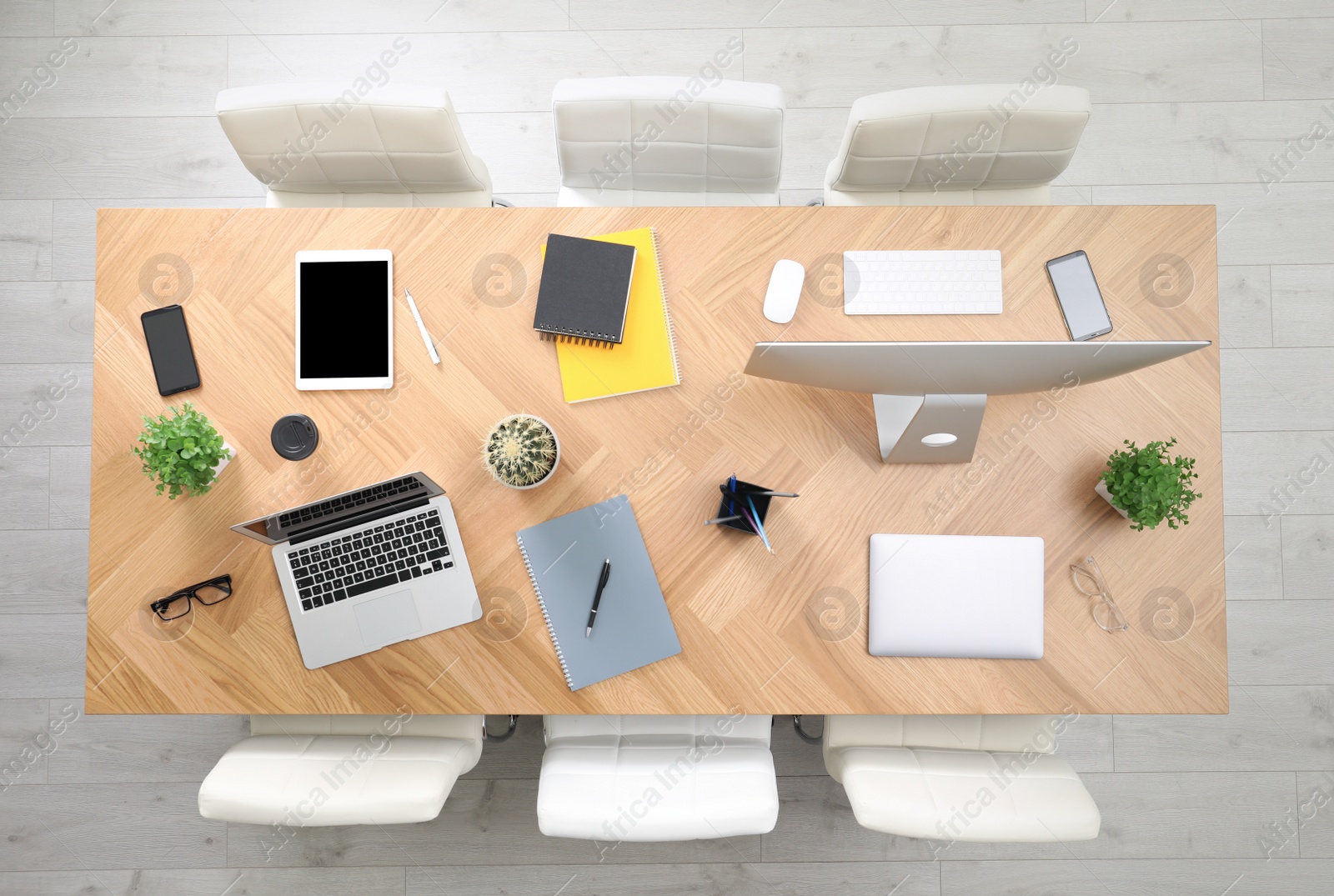 Photo of Modern office table with devices and chairs, top view