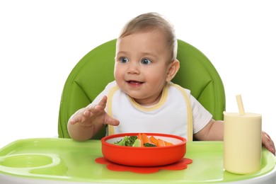 Photo of Cute little baby wearing bib while eating on white background