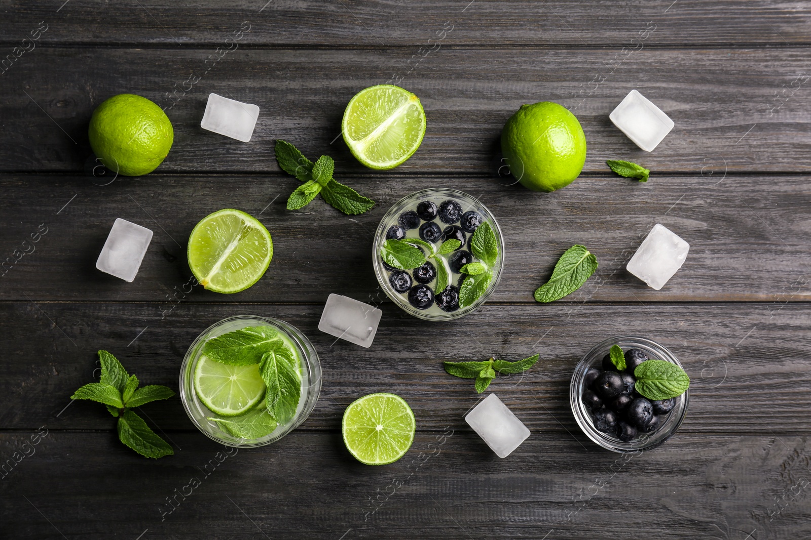 Photo of Flat lay composition with detox lemonade and ingredients on wooden background