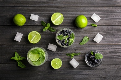 Flat lay composition with detox lemonade and ingredients on wooden background