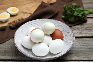 Photo of Plate with boiled eggs on wooden table