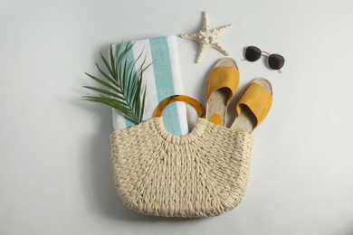 Composition with stylish beach accessories on white background, top view