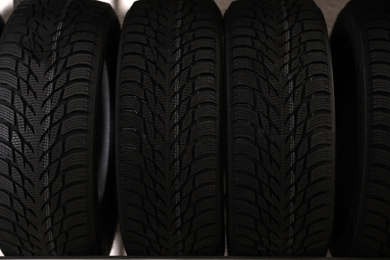 Car tires in auto store, closeup view