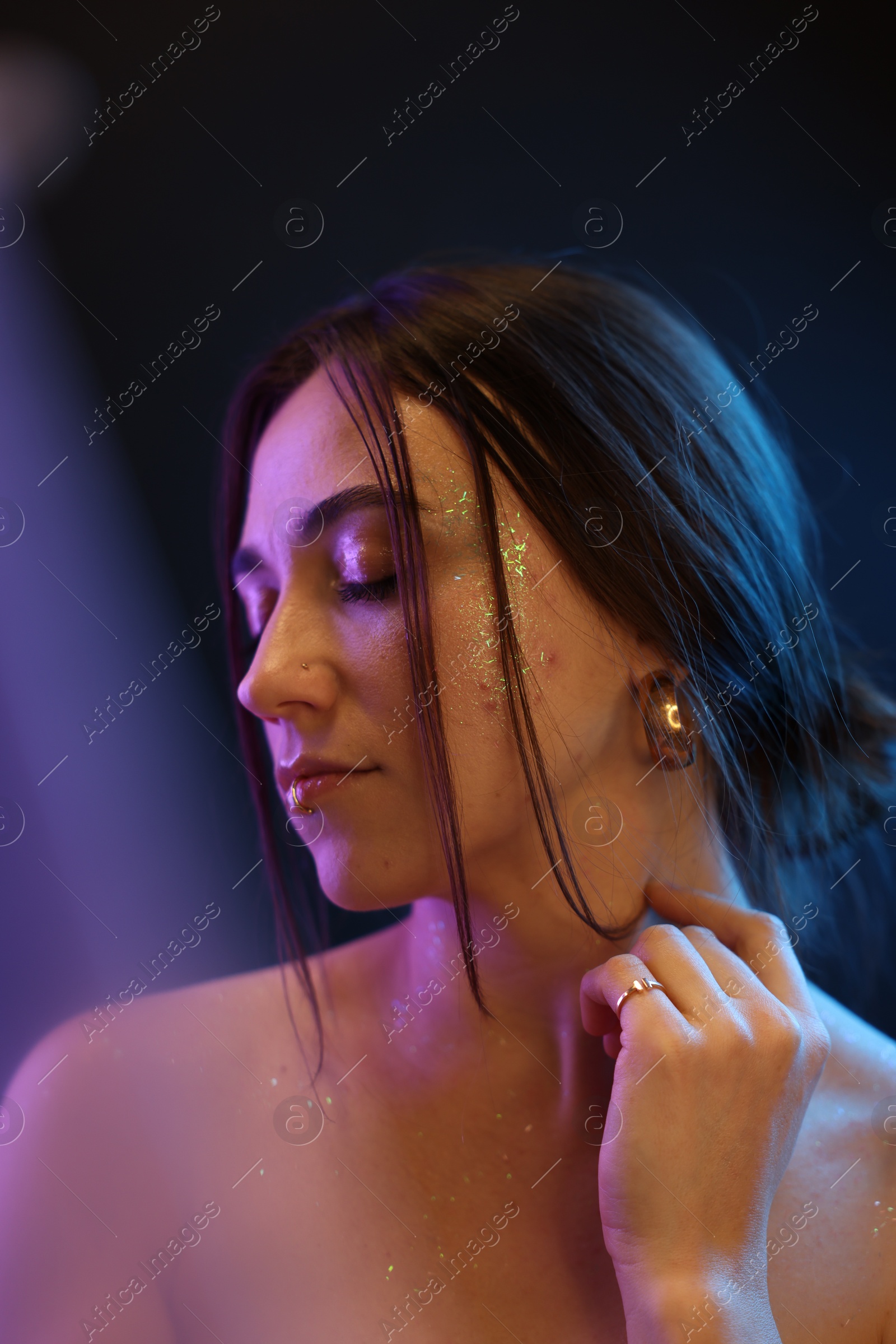 Photo of Portrait of beautiful woman on dark background in neon lights