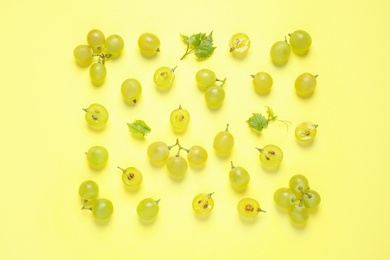 Photo of Flat lay composition with fresh ripe juicy grapes on yellow background