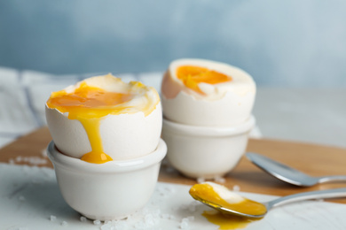 Photo of Soft boiled chicken eggs on white table, closeup