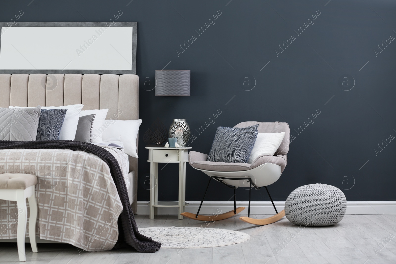 Photo of Elegant mirror over bed in stylish room interior