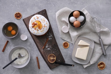 Flat lay composition with Easter cake and ingredients on light grey table