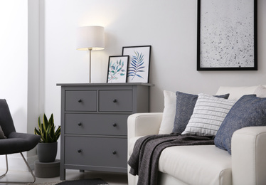 Photo of Modern room interior with grey chest of drawers
