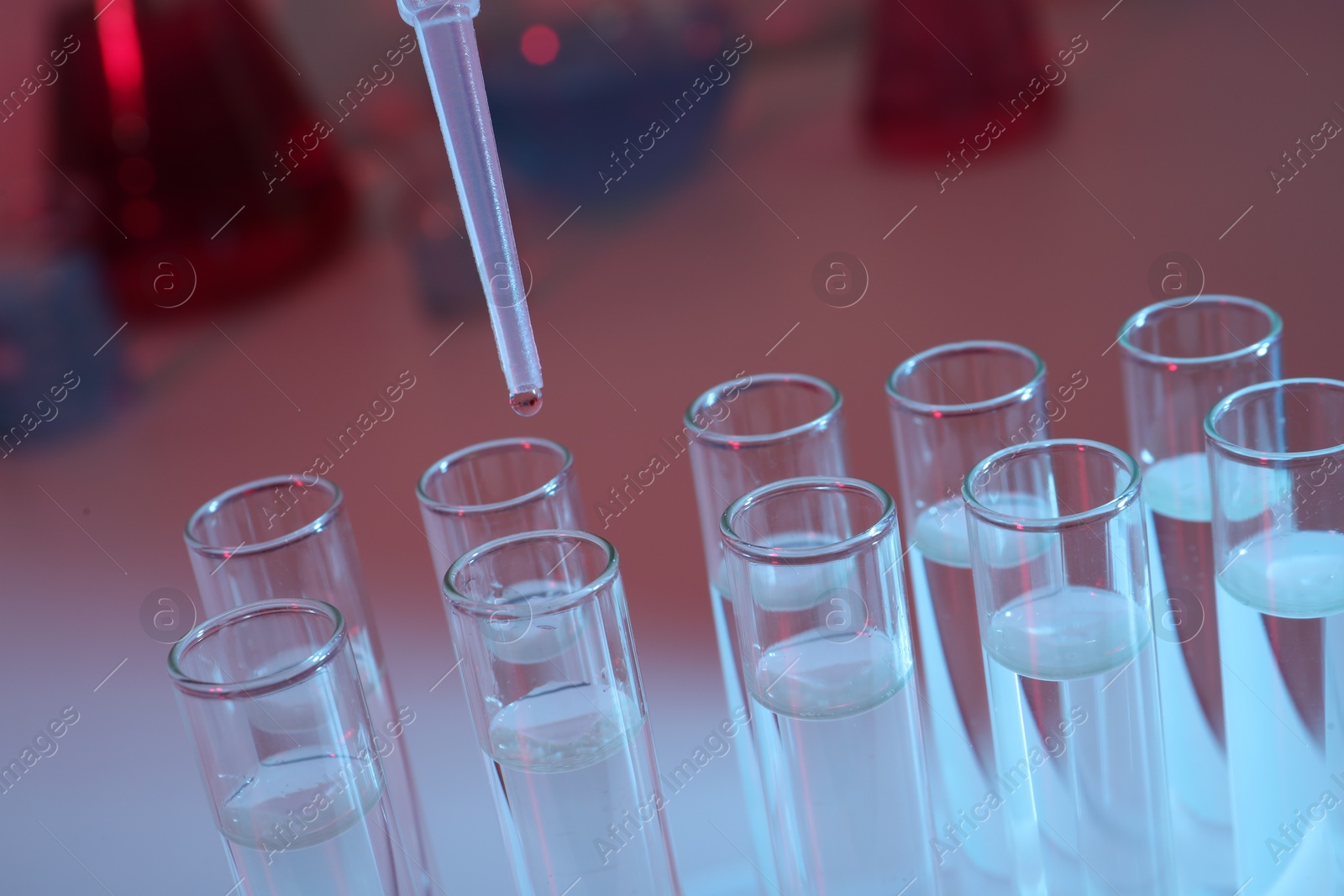 Photo of Dripping reagent into test tube, closeup. Laboratory analysis