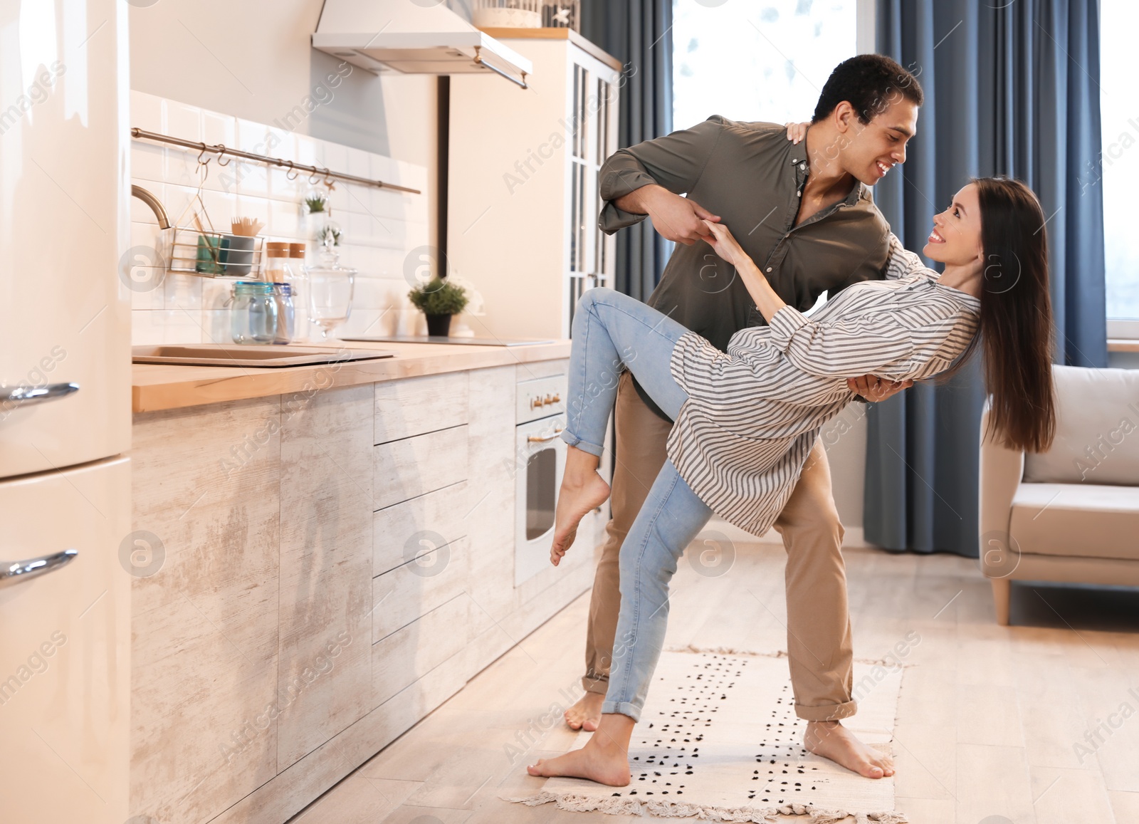 Photo of Lovely young interracial couple dancing at home