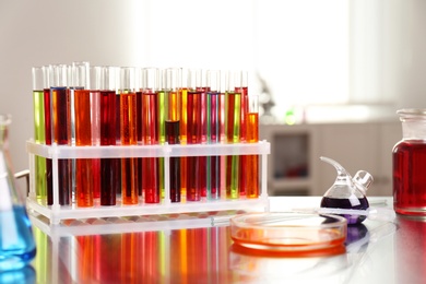 Photo of Laboratory glassware with color liquids on table. Solution chemistry