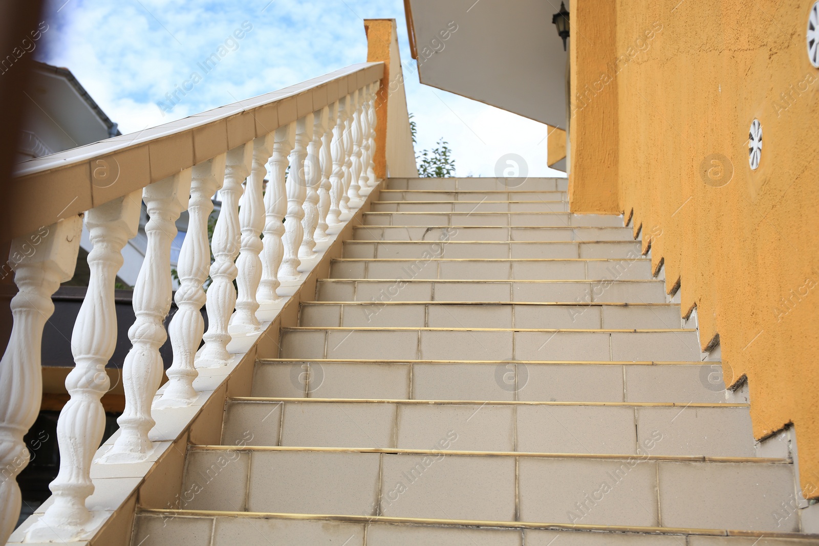 Photo of Beige house stairs outdoors on sunny day, low angle view