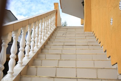 Photo of Beige house stairs outdoors on sunny day, low angle view
