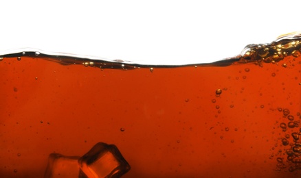 Closeup view of tasty refreshing cola with ice cubes on white background