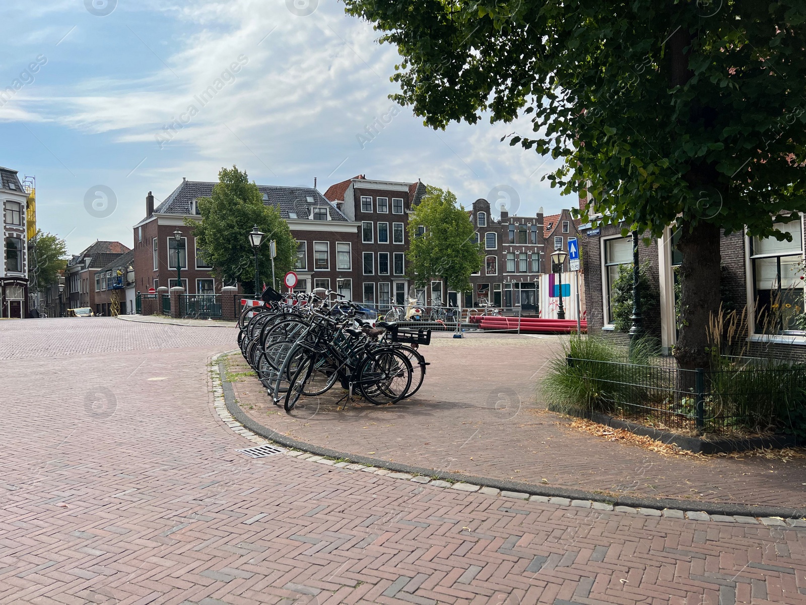 Photo of Beautiful view of parking with bicycles and buildings on city street