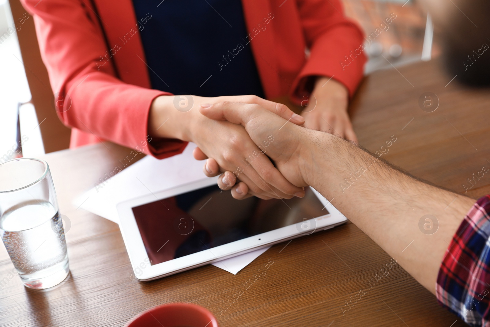 Photo of Business partners shaking hands after meeting, closeup