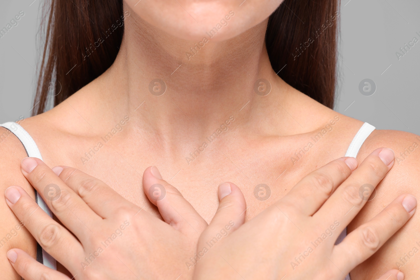 Photo of Closeup view of woman with normal skin on grey background