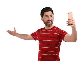 Photo of Smiling man taking selfie with smartphone on white background