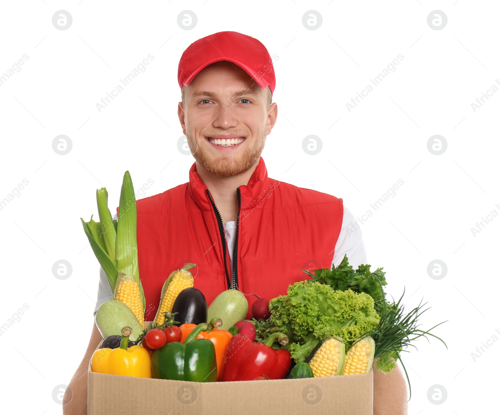 Photo of Delivery man with box of fresh vegetables on white background