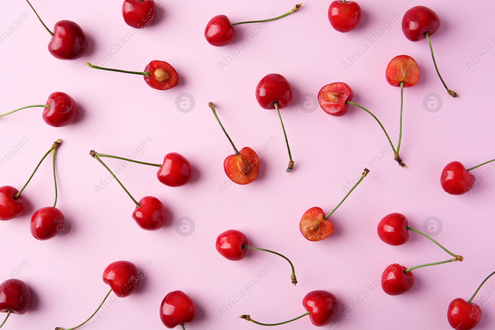 Photo of Ripe red cherries on color background, top view