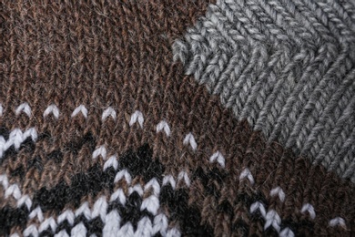 Photo of Knitted soft woolen sock as background, closeup