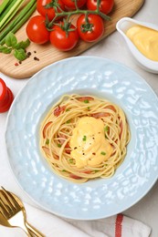 Photo of Delicious spaghetti with meat and cheese sauce served on light grey table, flat lay