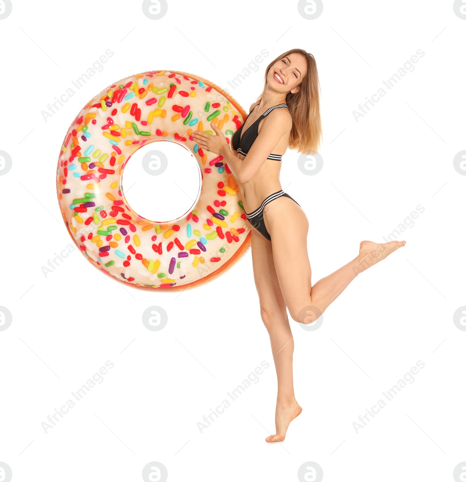 Photo of Beautiful young woman in stylish bikini with doughnut inflatable ring on white background