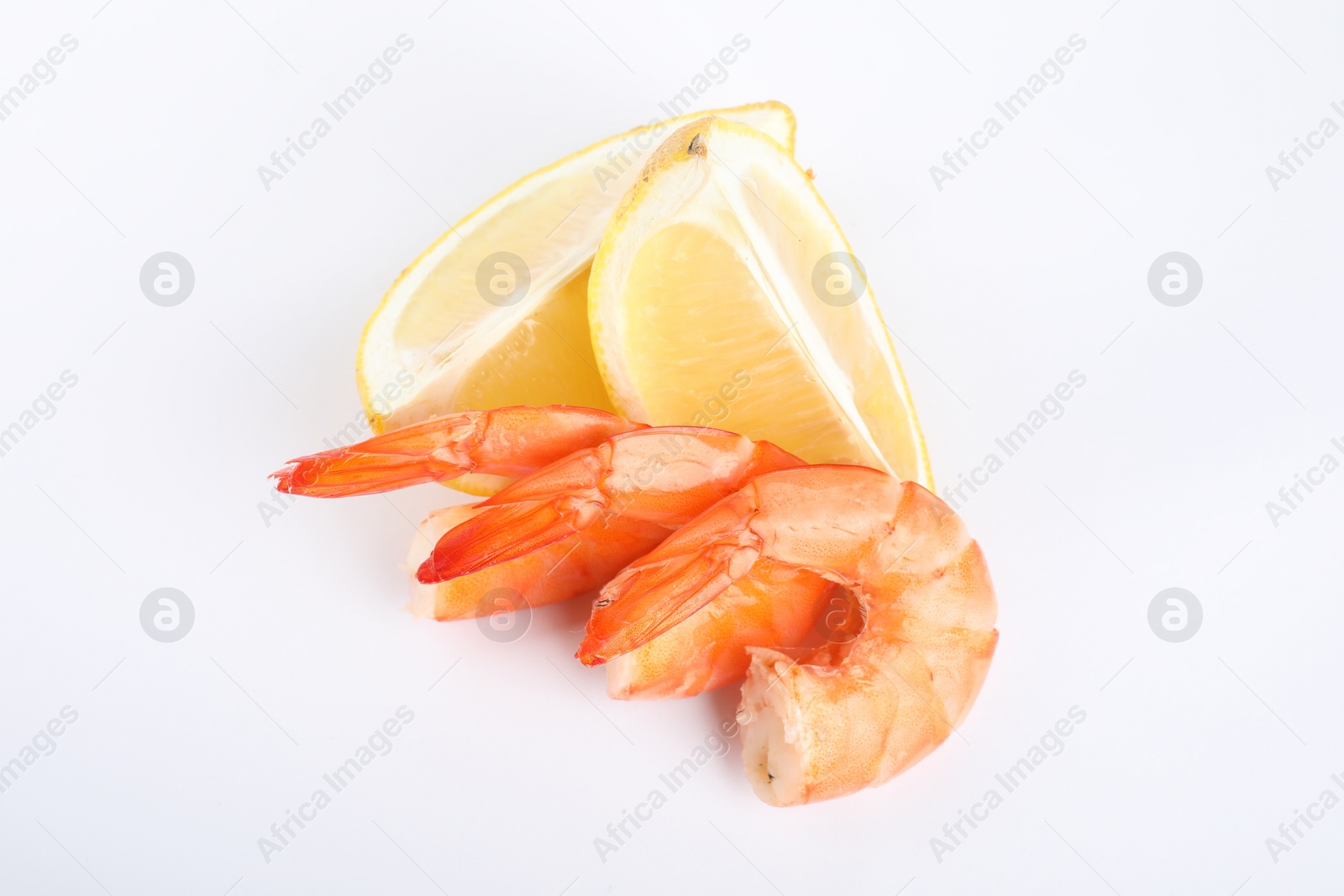 Photo of Delicious cooked shrimps and lemon isolated on white