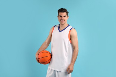 Photo of Basketball player with ball on light blue background