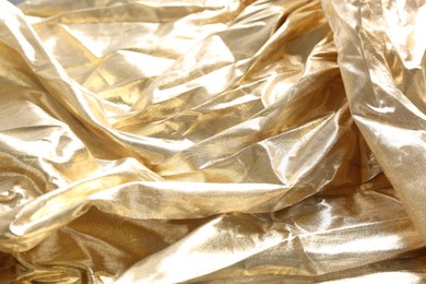 Photo of Closeup view of golden shiny fabric as background