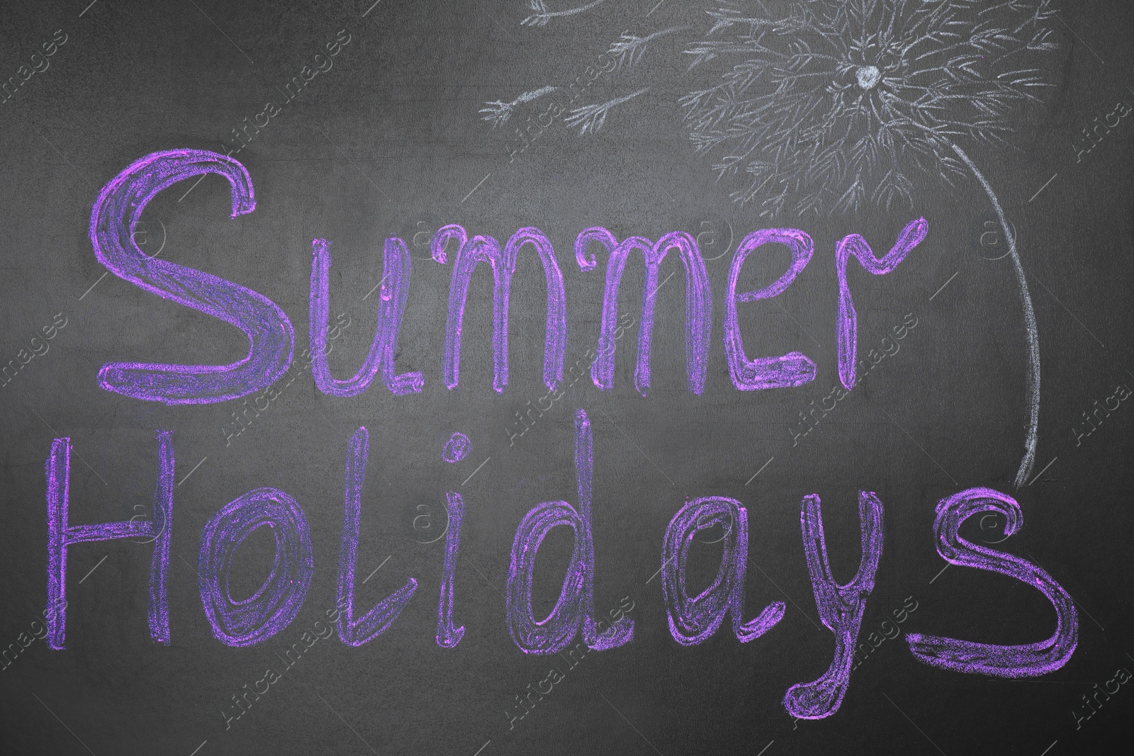 Photo of Phrase SUMMER HOLIDAYS written on black background. School's out
