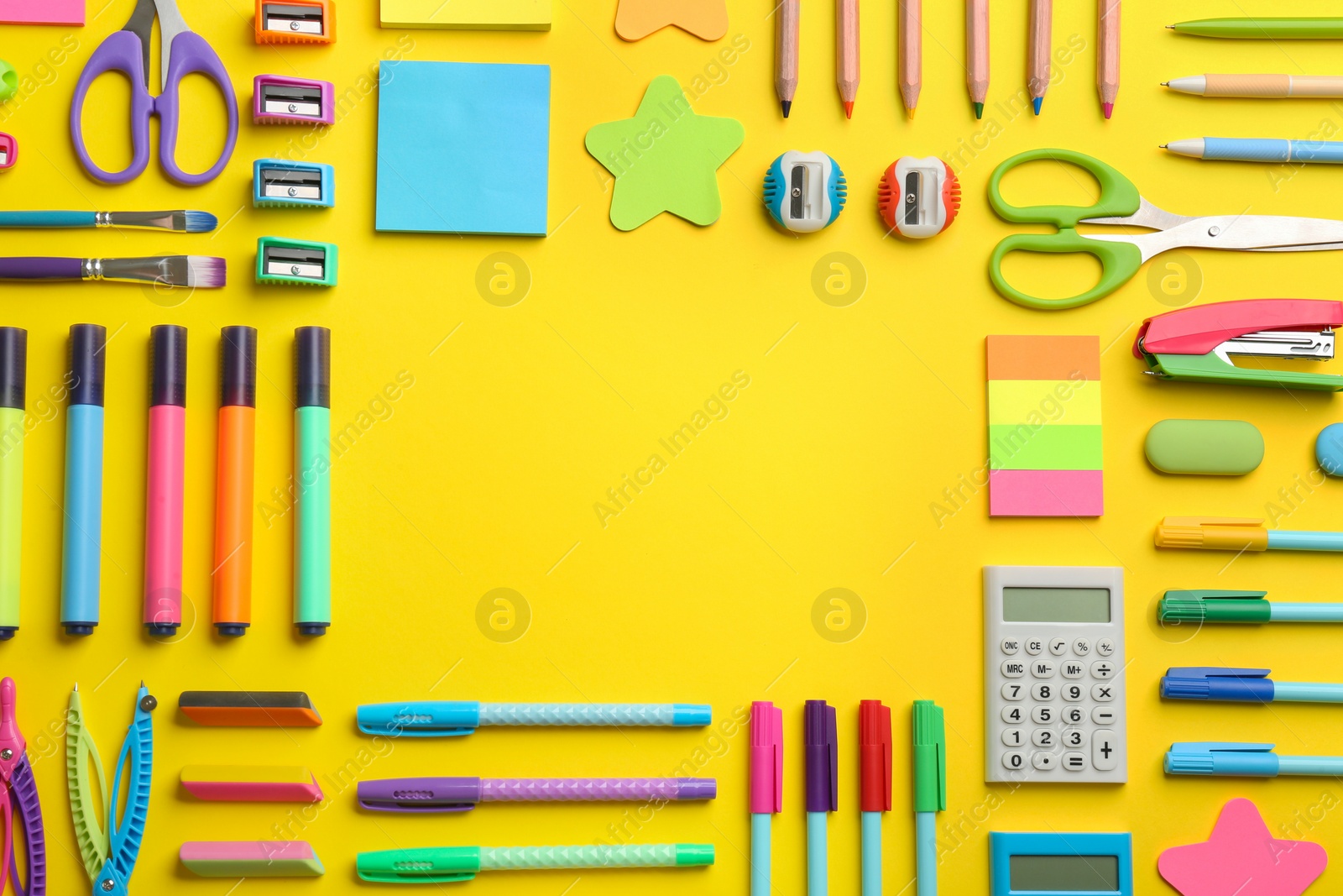 Photo of Frame of school stationery on yellow background, flat lay with space for text. Back to school