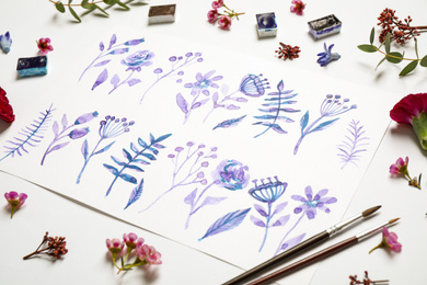 Photo of Composition with floral picture and watercolor paints on white background