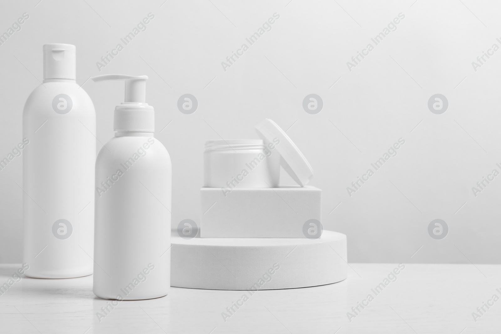 Photo of Different cosmetic products on white wooden table. Space for text