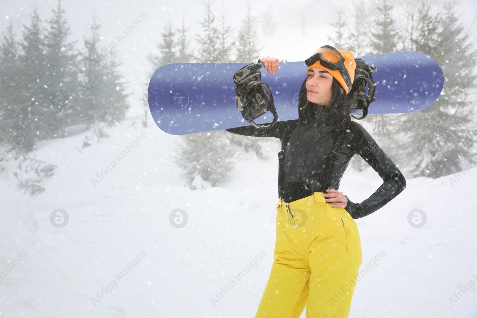 Photo of Young woman with snowboard wearing winter sport clothes outdoors