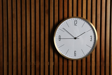 Stylish clock and space for text on wooden background. Time management