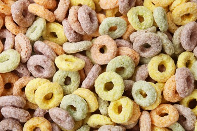 Photo of Tasty cereal rings as background, top view