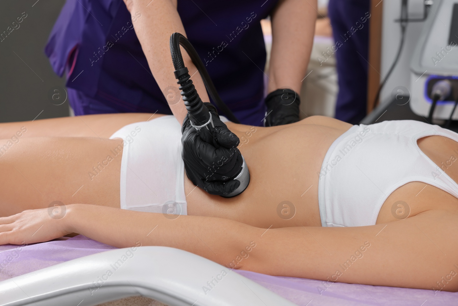 Photo of Woman undergoing radio frequency lifting procedure in beauty salon, closeup