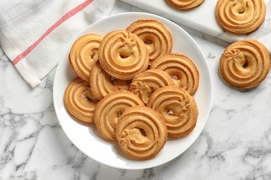 Photo of Plate with Danish butter cookies on marble table, top view