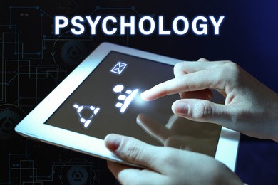 Psychologist working with modern tablet on color background, closeup 