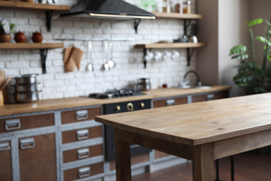 Photo of Empty wooden table in beautiful kitchen. Interior design
