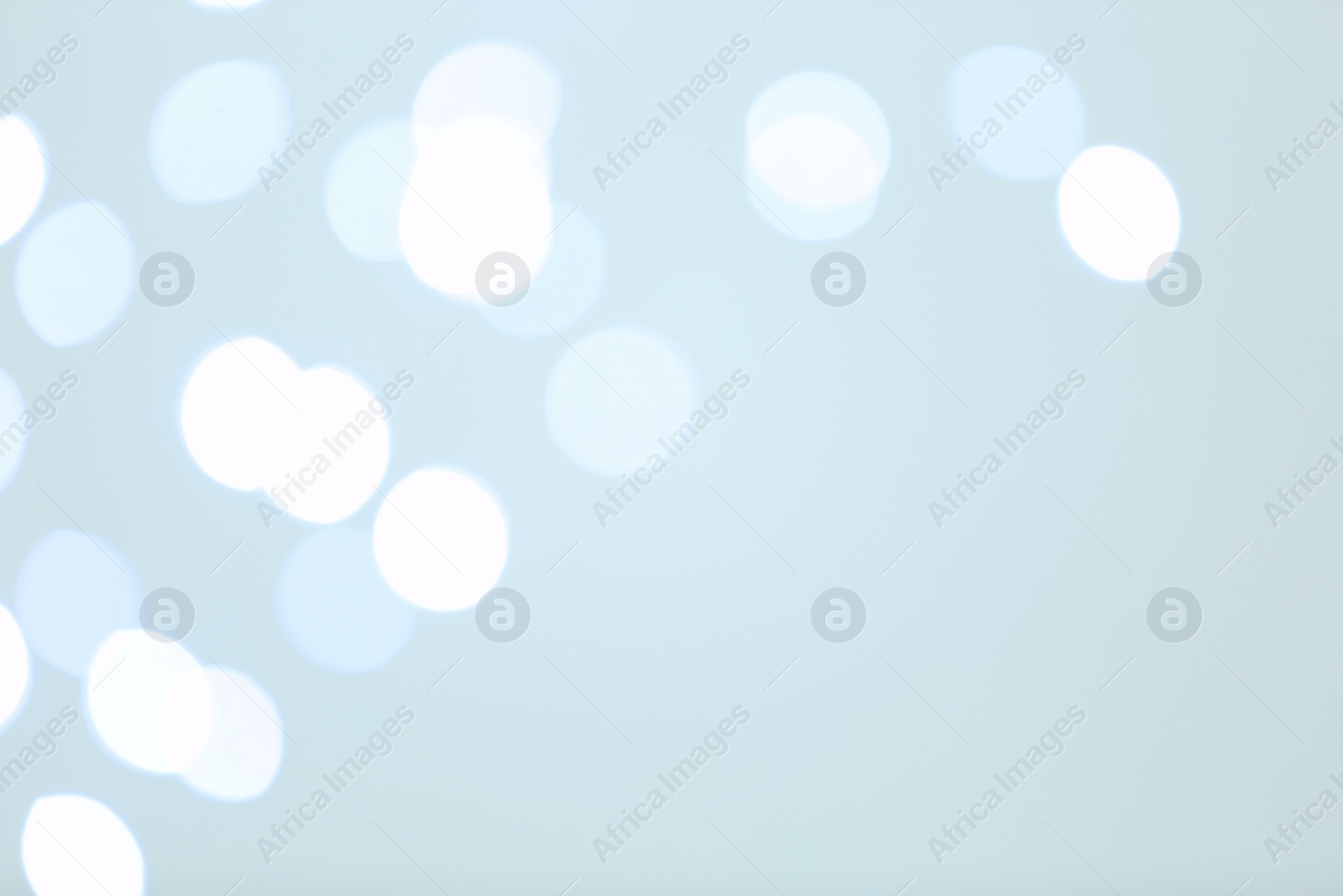 Photo of Beautiful blurred lights on bright background, bokeh effect. Space for text